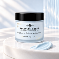 Harvest & Hive Premium GHK-Cu Tallow Balm in a pale blue frosted jar with a black lid and black logo, beside a blue balm swatch.